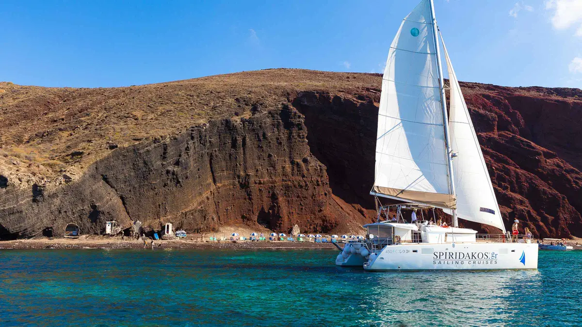 Luxury sailing catamaran with sundeck on a Santorini catamaran cruise with BBQ and drinks
