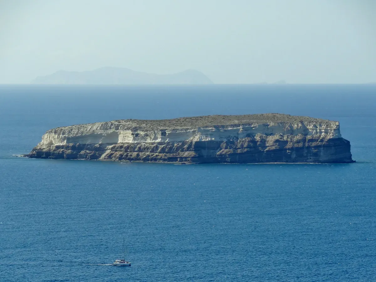 Aspronisi, the white volcanic islet at the south-west edge of the Santorini caldera, on a catamaran cruise